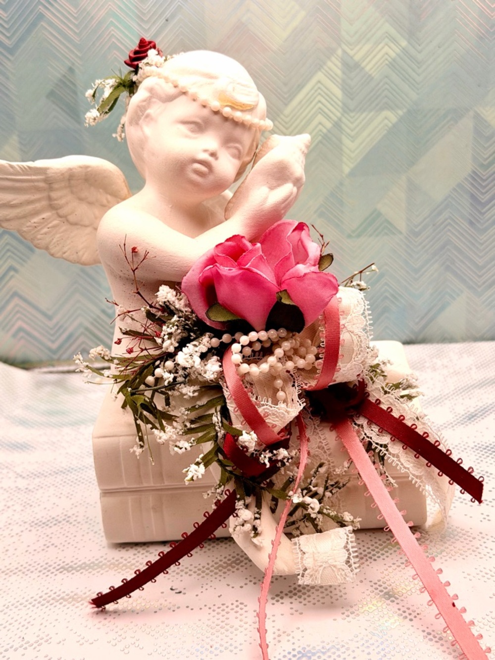 Elegant White Cherub Statue with Pink Rose Bouquet Accent